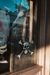 Halloween decorations in window with gravestone