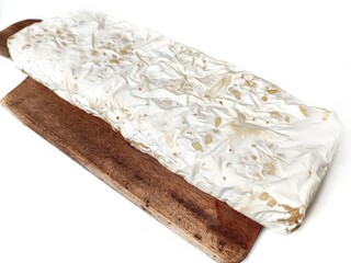 Fresh tempeh on a wooden cutting board. Food from Indonesia from soybean fermentation