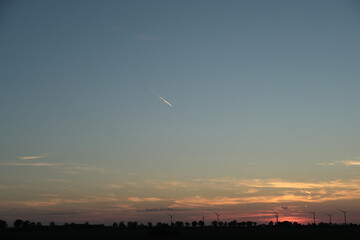 sunset with a plane in the sky