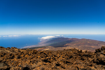 Breathtaking view of volcanic landscape overlooking the ocean from a high elevation on a clear day