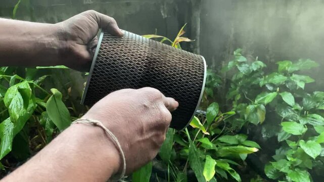 Hand blowing on car air filter.Car air filter maintenance
