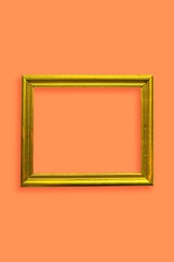 gold photo frame in a orange wall vertical