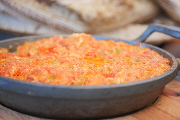 Turkish Menemen omelet in a frying pan. .