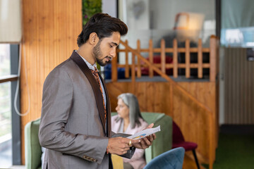 Fototapeta premium Hardworking young adult businessman, checking the company budget in the files