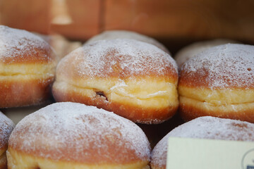 Experience a Decadent and Delicious Assortment of Powdered Sugar Donuts filled with Berry Filling