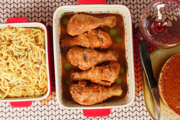 Delicious and hearty Baked Chicken Drumsticks served in a Red and White Dish with Garnish