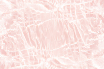 Pink water bubbles on the surface ripple. Defocus blurred transparent pink colored clear calm water surface texture with splash and bubbles. Water waves with shining pattern texture background