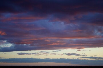 thick clouds in the sky with bluish and orange hues during sunset