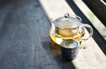 Chamomile tea in a clear teapot.