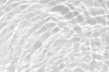 White water with ripples on the surface. Defocus blurred transparent white colored clear calm water surface texture with splashes and bubbles. Water waves with shining pattern texture background.