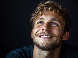 Fototapeta premium A cheerful young man smiles brightly, showcasing happiness and warmth in a captivating portrait.