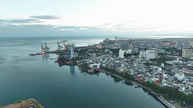 INDONESIA - 9.4.2024 - Great aerial footage circling near the urban coastline of Makassar, Indonesia.