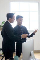 Two Professional Businessman Manager Explaining Chart or Graph on Paperwork