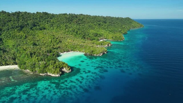 INDONESIA - 9.4.2024 - Incredible aerial footage approaching Indonesia's tree-covered Malenge Island.