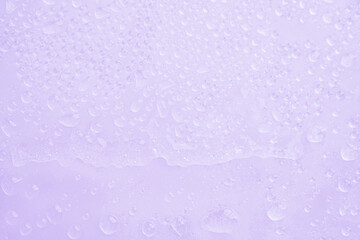 Purple background of water drops from the cold ice in the frozen. Soft blurred sweet purple texture background. 