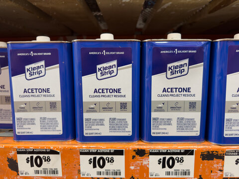 Tin cans of Acetone by Klean Strip on a shelf of a Home Depot store