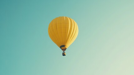 Fototapeta premium A yellow hot air balloon floating gracefully in a clear blue sky, symbolizing adventure and exploration.
