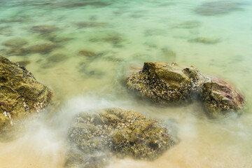 Long exposure photo of Nature’s Harmony: Rocks and Waves in Perfect Balance.