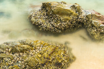 Long exposure photo of Nature’s Harmony: Rocks and Waves in Perfect Balance.