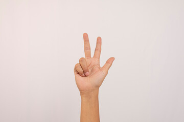 Close-up of Caucasian male hand showing number three gesture isolated on white studio background. Hand number concept for people with disabilities.