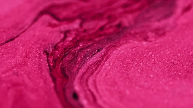Ink emulsion. Glitter flow. Glowing texture crimson pink red black mix pigment sparkling particles motion hypnotical abstract art background.