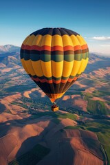 Obraz premium Vintage hot air balloon flying over a scenic landscape