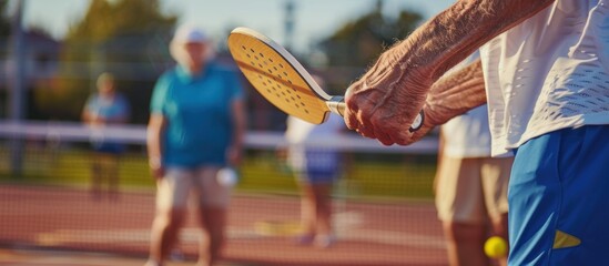 Senior Man Holding Pickleball Paddle