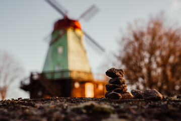 Stacked Stones with a Windmill in the Background