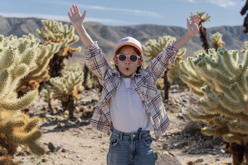 Child girl exploring Joshua Tree National park, enjoy Cholla cactus garden