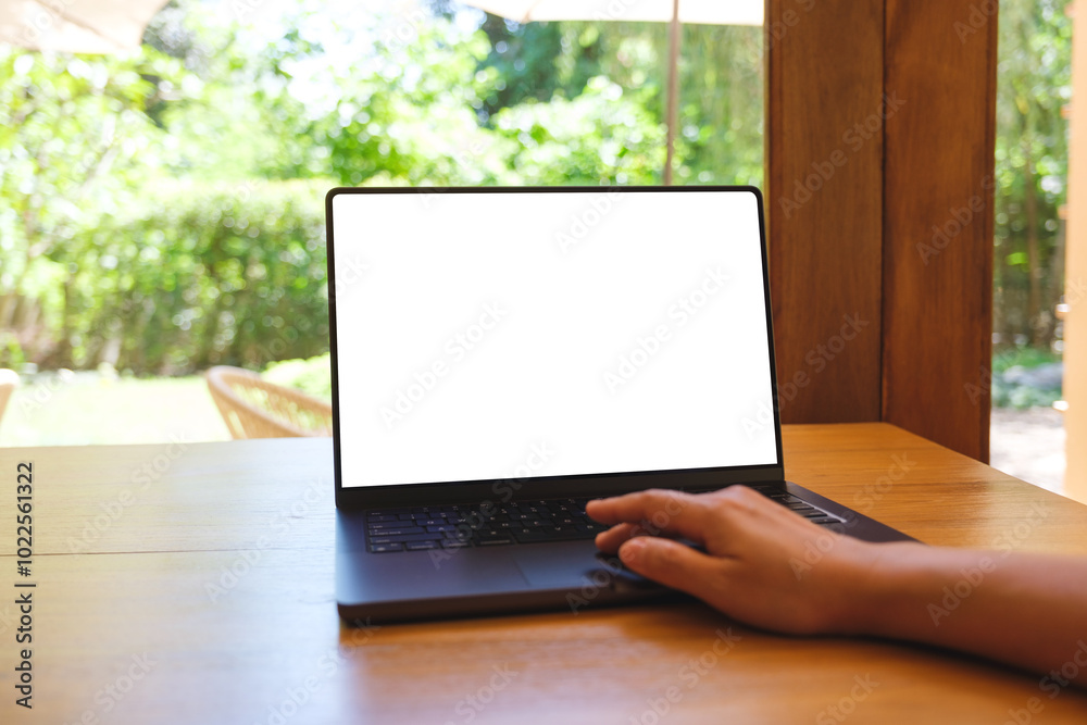 Wall mural mockup image of a woman using and touching on laptop computer with blank white desktop screen on woo