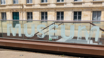 Museum text sign on windows step entrance modern lettering