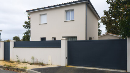 facade of white modern house with large grey portal of new suburban home