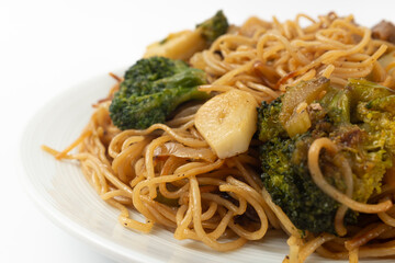 Stir-fried Hong Kong-style egg noodles on a white background