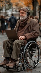 Elderly disabled man using a wheelchair, laptop, and headphones.