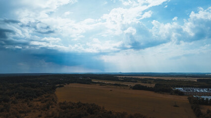 Aerial view of green fields with storm clouds