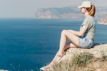 Woman Gazing at the Sea from a Clifftop