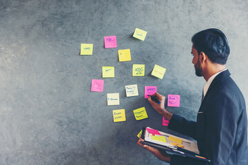 Business Professional Writing on Sticky Notes: Planning, Strategy, and Creative Idea Development...