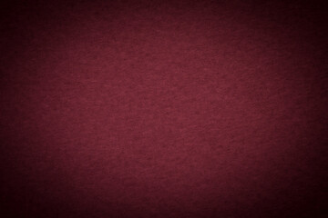 background for holiday card: close up of shadowed maroon cardboard texture