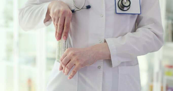 Doctor puts hundred dollar bill in pocket