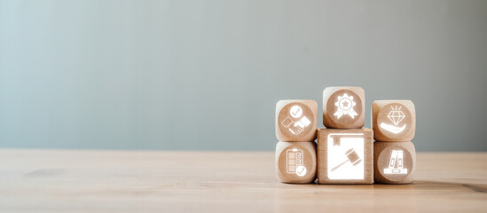 Wooden blocks with icons symbolizing ethics, rules, and standards, representing the concept of a...