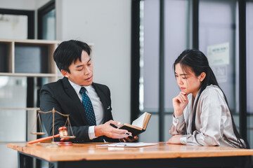 Lawyer discussing legal matters with a client in a modern office. Professional business...