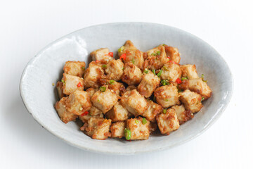 Stirred Tofu: Vegetarian Asian Style.This vibrant dish features crispy stir-fried tofu, perfectly marinated for flavor and texture. The tofu is coated in soy sauce and sesame oil, a rich umami taste.