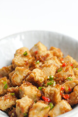 Stirred Tofu: Vegetarian Asian Style.This vibrant dish features crispy stir-fried tofu, perfectly marinated for flavor and texture. The tofu is coated in soy sauce and sesame oil, a rich umami taste.