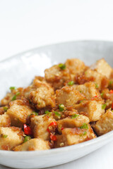 Stirred Tofu: Vegetarian Asian Style.This vibrant dish features crispy stir-fried tofu, perfectly marinated for flavor and texture. The tofu is coated in soy sauce and sesame oil, a rich umami taste.