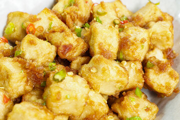 Stirred Tofu: Vegetarian Asian Style.This vibrant dish features crispy stir-fried tofu, perfectly marinated for flavor and texture. The tofu is coated in soy sauce and sesame oil, a rich umami taste.