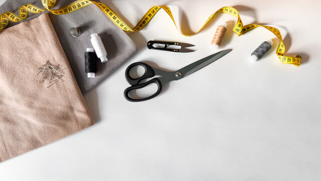 Sewing essentials flat lay with fabric, scissors, and measuring tape - Powered by Adobe