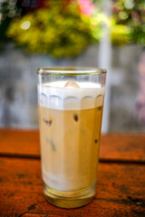 a cup of cold cappuccino iced coffee served in a cafe