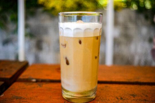 a cup of cold cappuccino iced coffee served in a cafe