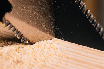 Detail of the teeth of a Japanese saw sawing.