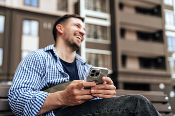 Young man sitting on a bench in a park